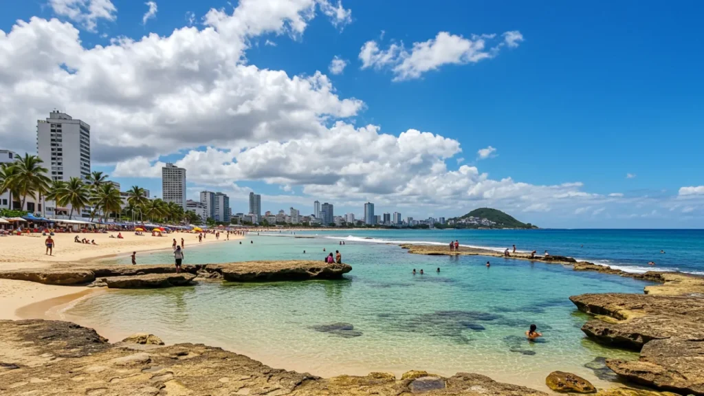 Praia de Boa Viagem Recife com piscinas naturais de coral e banhistas aproveitando